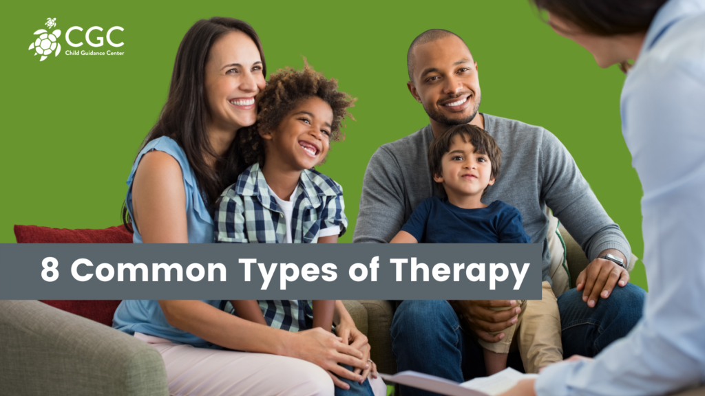 "8 Common Types of Therapy" overlaid on a photo of a family looking toward a therapist who is mostly off screen. The family includes a woman, man, and two young boys who are sitting in the adults' laps.