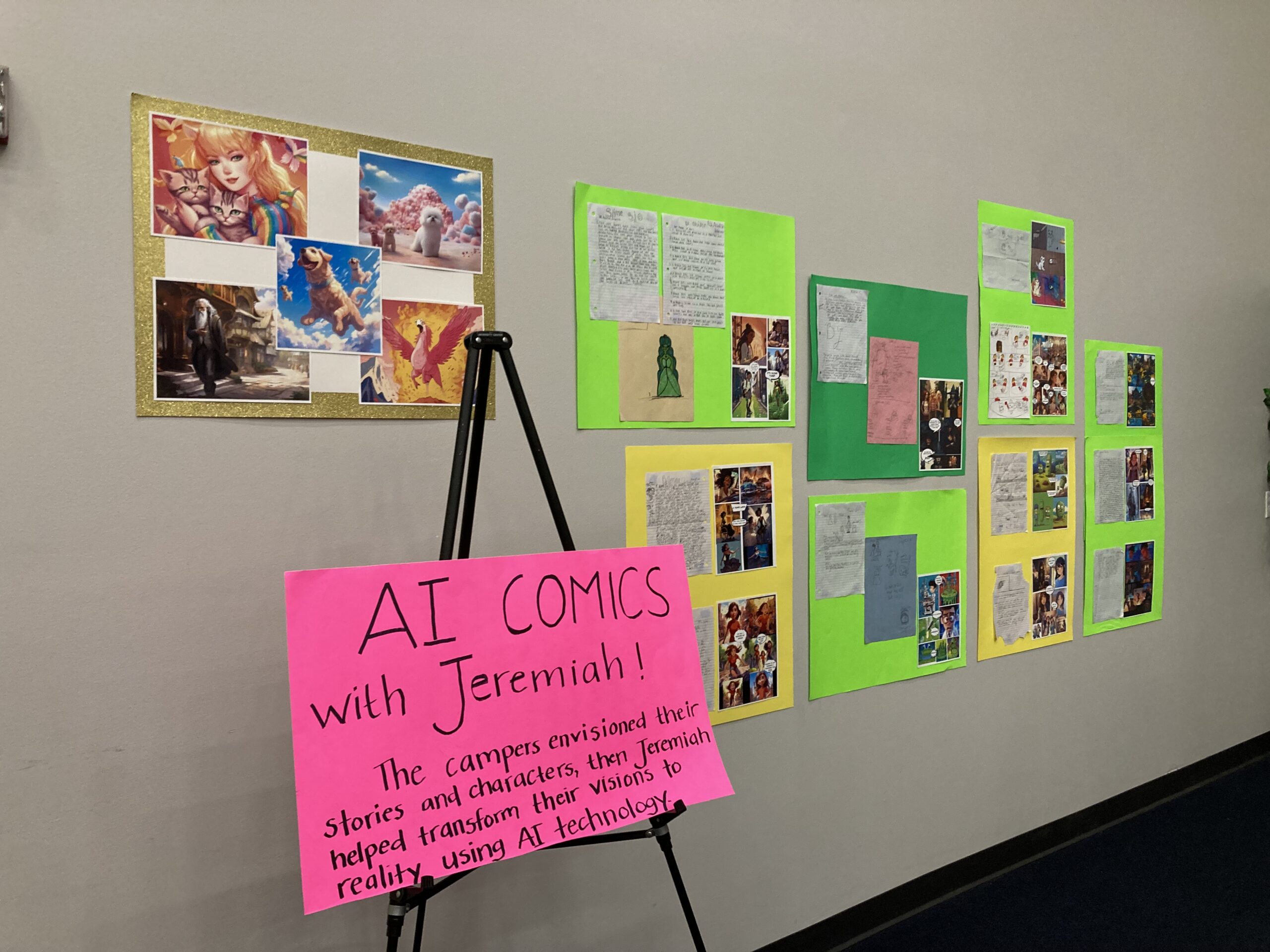 A poster reading "AI Comics with Jeremiah" is sitting on an easel in front of a wall with a gallery of comics created by the campers.